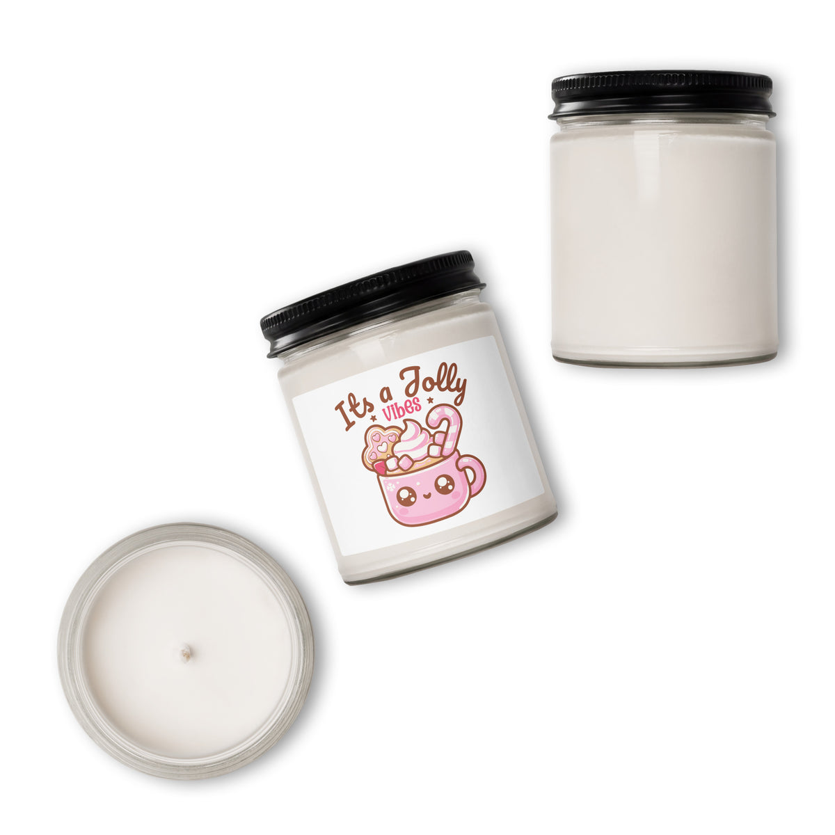 A white soy wax candle in a clear glass jar with a black lid, shown in three views: one with a printed label reading 'It's a Jolly Jolly' and a pink mug illustration, one showing the full jar, and one showing the open lid with wax visible.