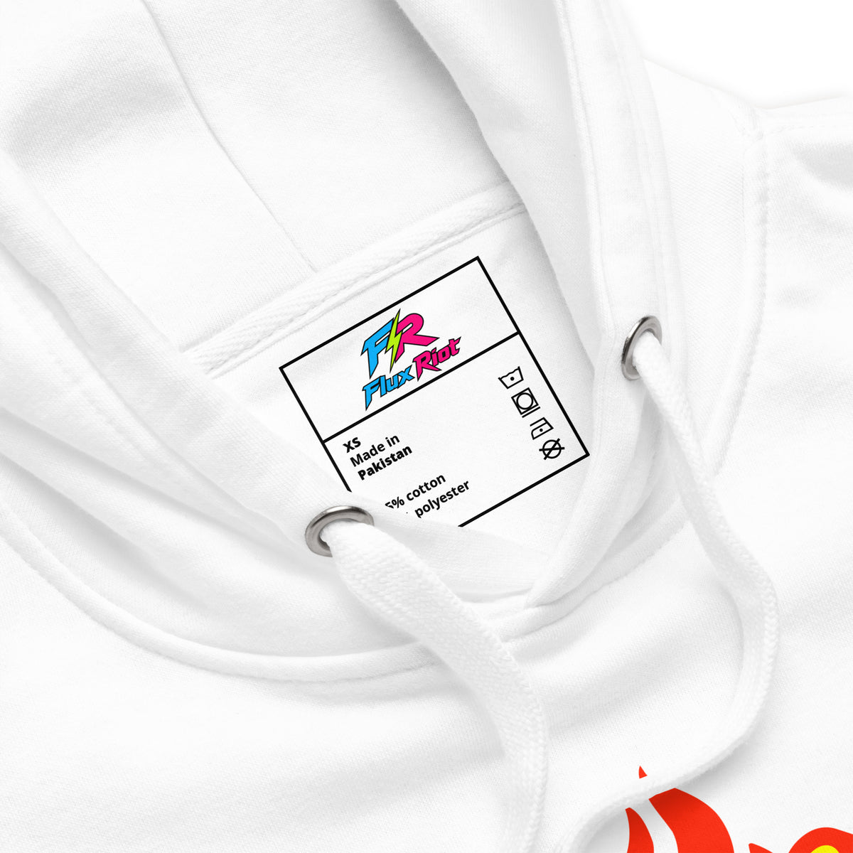 Close-up of a white hoodie showing the inner neck label with the 'Fiction Factory' logo and 'XXL Made in Pakistan' text, along with white drawstrings and metal eyelets.