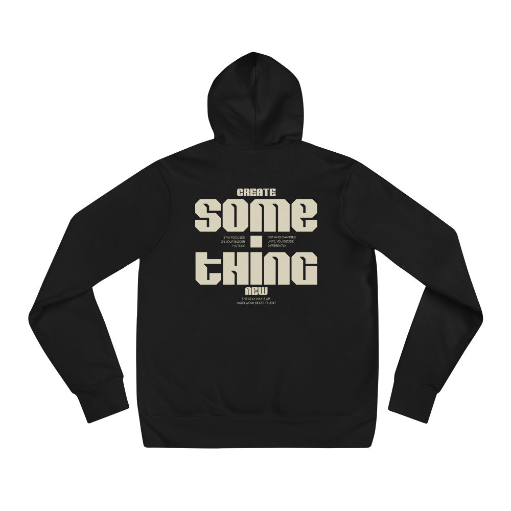 A black pullover hoodie shown from the back, featuring a large beige graphic print that reads 'CREATE SOME THING NEW' with smaller text above and below, displayed on a solid white background.