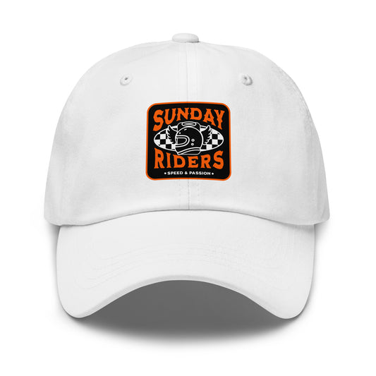 A white baseball cap featuring a square orange, black, and white graphic on the front that reads 'SUNDAY RIDERS' with a helmet and checkered pattern, shown on a plain white background.