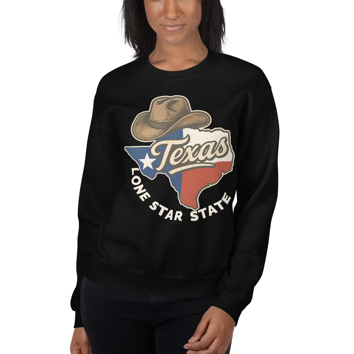 A woman wearing a black crewneck sweatshirt with a graphic of a cowboy hat, the state of Texas in red, white, and blue, and the words 'Texas Lone Star State' printed on the front.