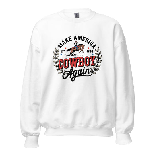 A white crewneck sweatshirt featuring a graphic print on the front with the text 'MAKE AMERICA COWBOY Again' in black and red, flanked by a cowboy riding a horse and leafy branches.