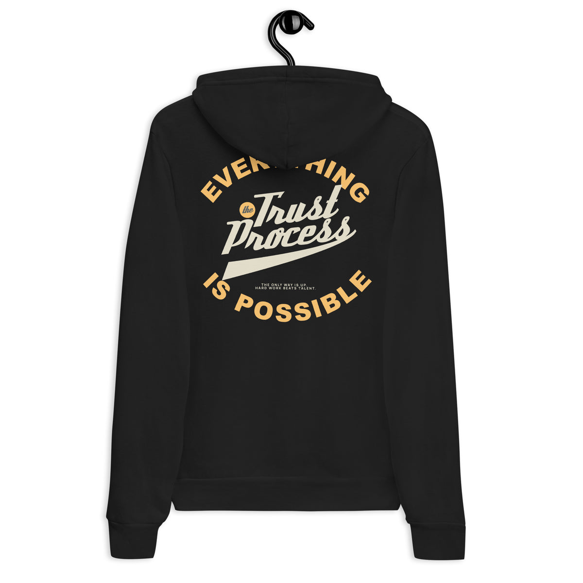 A black pullover hoodie hanging on a black hanger against a plain white background, showing the back view with a large graphic print in gold and white text that reads 'Everything Trust Process Is Possible'.