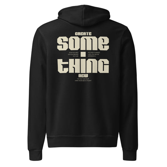A black pullover hoodie shown from the back, featuring a large beige graphic text print that reads 'CREATE SOME THING NEW' with smaller text elements around it, on a plain white background.