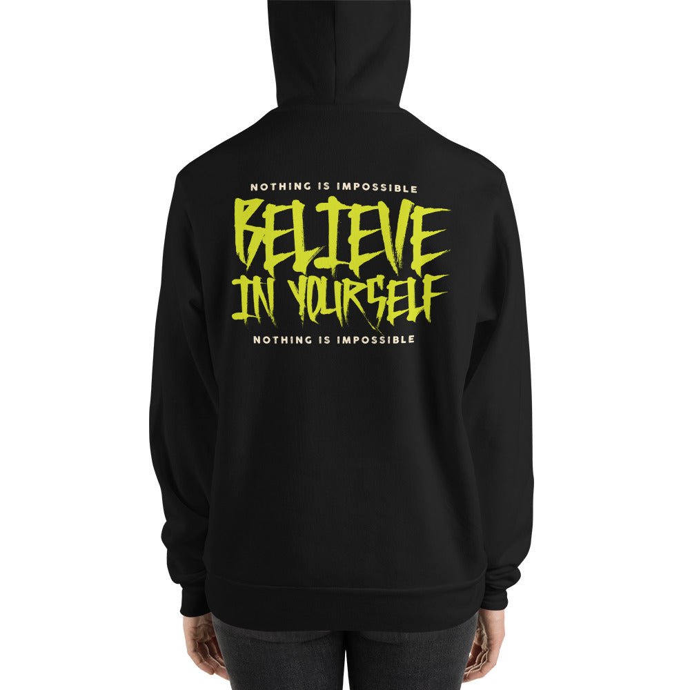 A person shown from the back wearing a black hoodie with a large graphic on the back. The design features the phrase 'BELIEVE IN YOURSELF' in a bold, jagged yellow font, with 'NOTHING IS IMPOSSIBLE' written in smaller white text above and below.