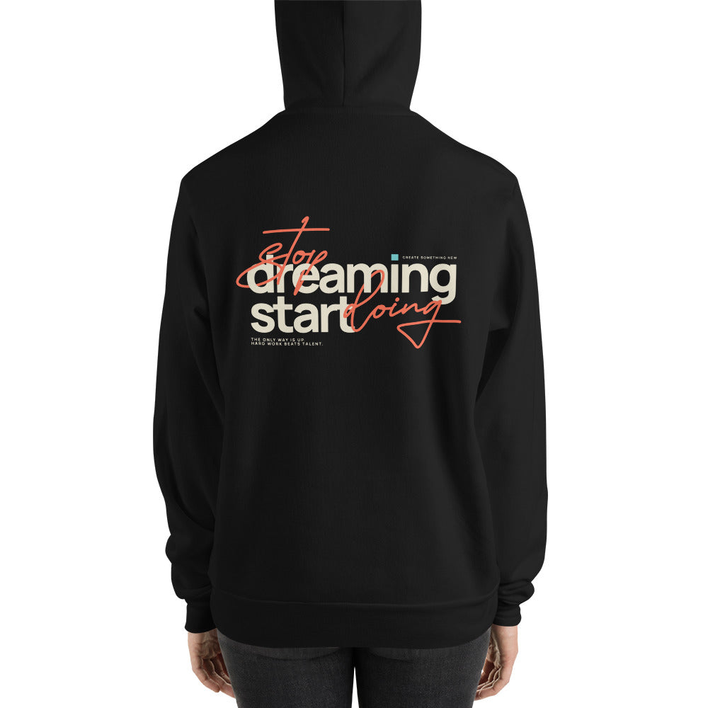 A person shown from the back wearing a black hoodie with a large graphic on the back. The graphic reads 'Stop dreaming start doing' in white and orange script and block lettering, with smaller text below.