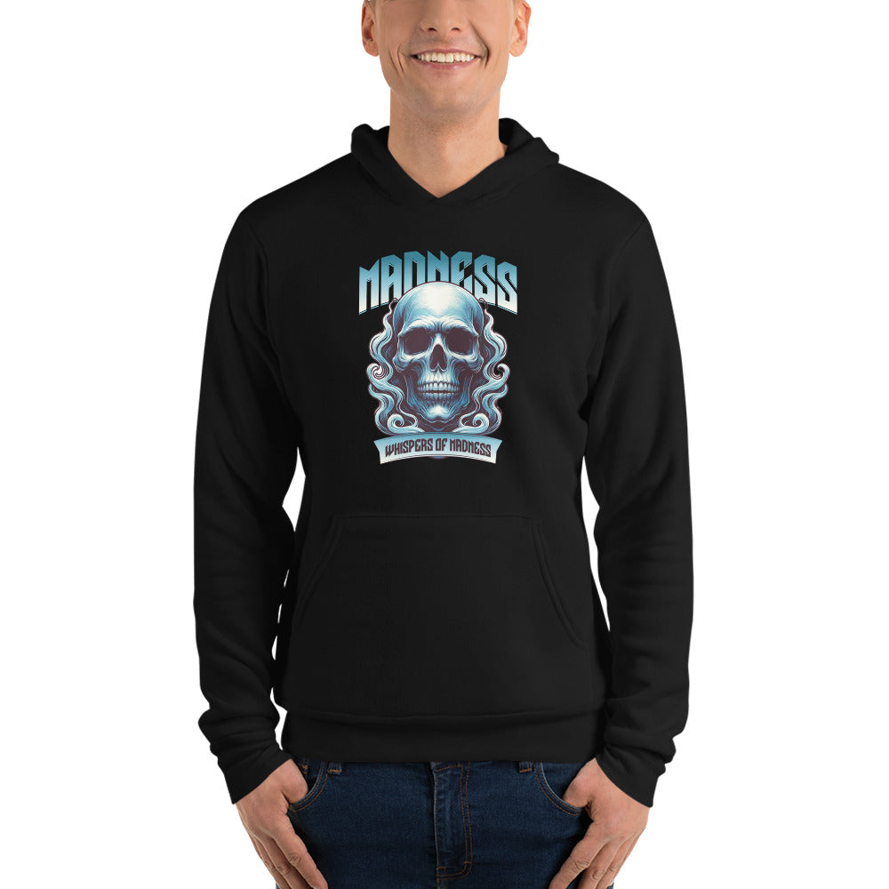 A man wearing a black pullover hoodie with a blue and white skull graphic and the word 'MADNESS' printed on the chest, paired with blue jeans against a plain white background.