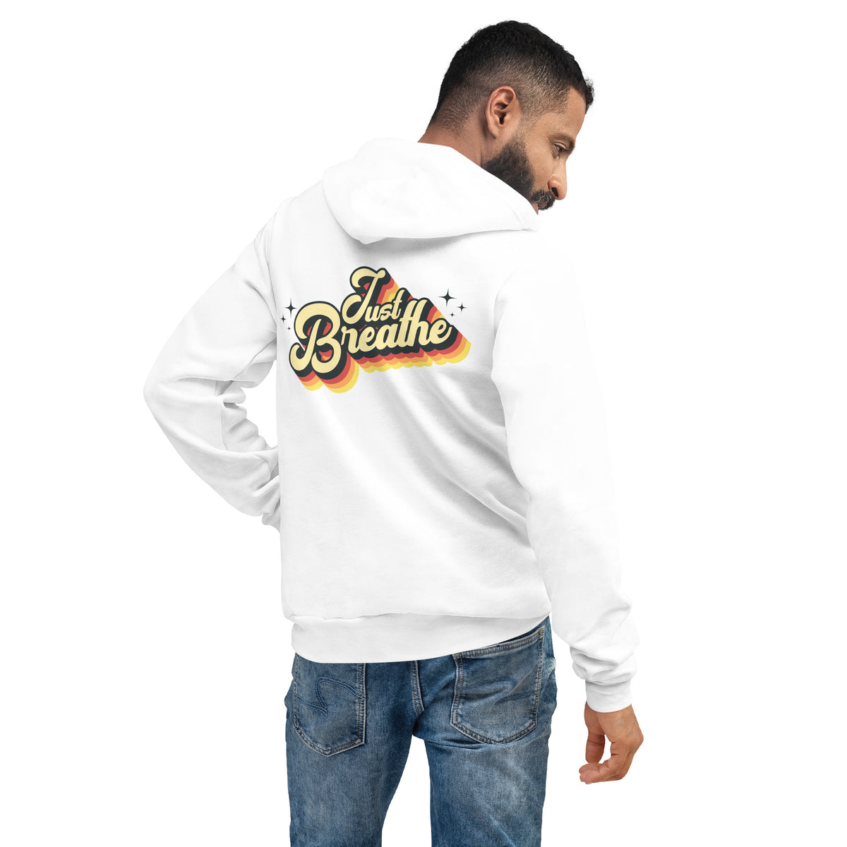 A man wearing a white hoodie from the back, showing a colorful graphic that reads 'Just Breathe' in yellow, orange, and red. He is also wearing blue jeans against a plain white background.
