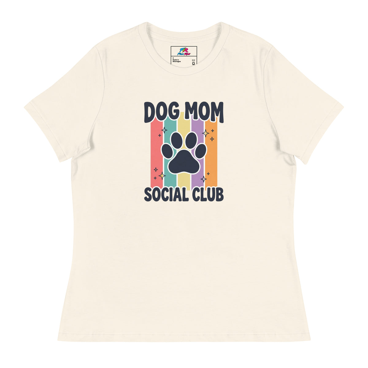 An off-white short-sleeve t-shirt with a 'Dog Mom Social Club' graphic on the front, featuring a colorful retro stripe design and a dark navy paw print.